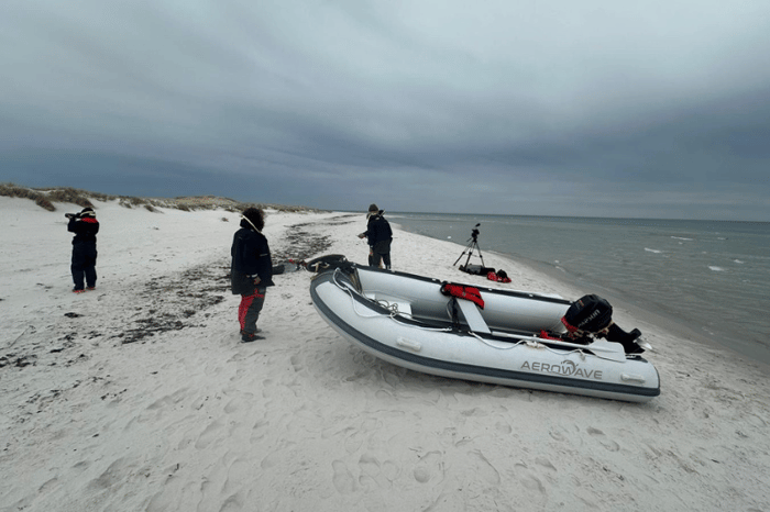 Aerowave inflatable boat with outboard motor beach-launched on an Australian shoreline