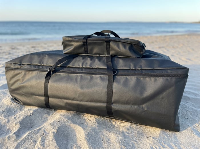 Aerowave inflatable boat kit laid out on an Australian beach with carry bag, wheel bag and pump