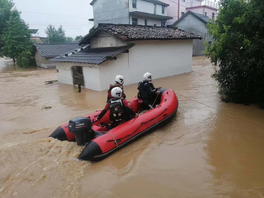 Aerowave Sport Series inflatable boat under outboard power with rescue personnel in floodwater