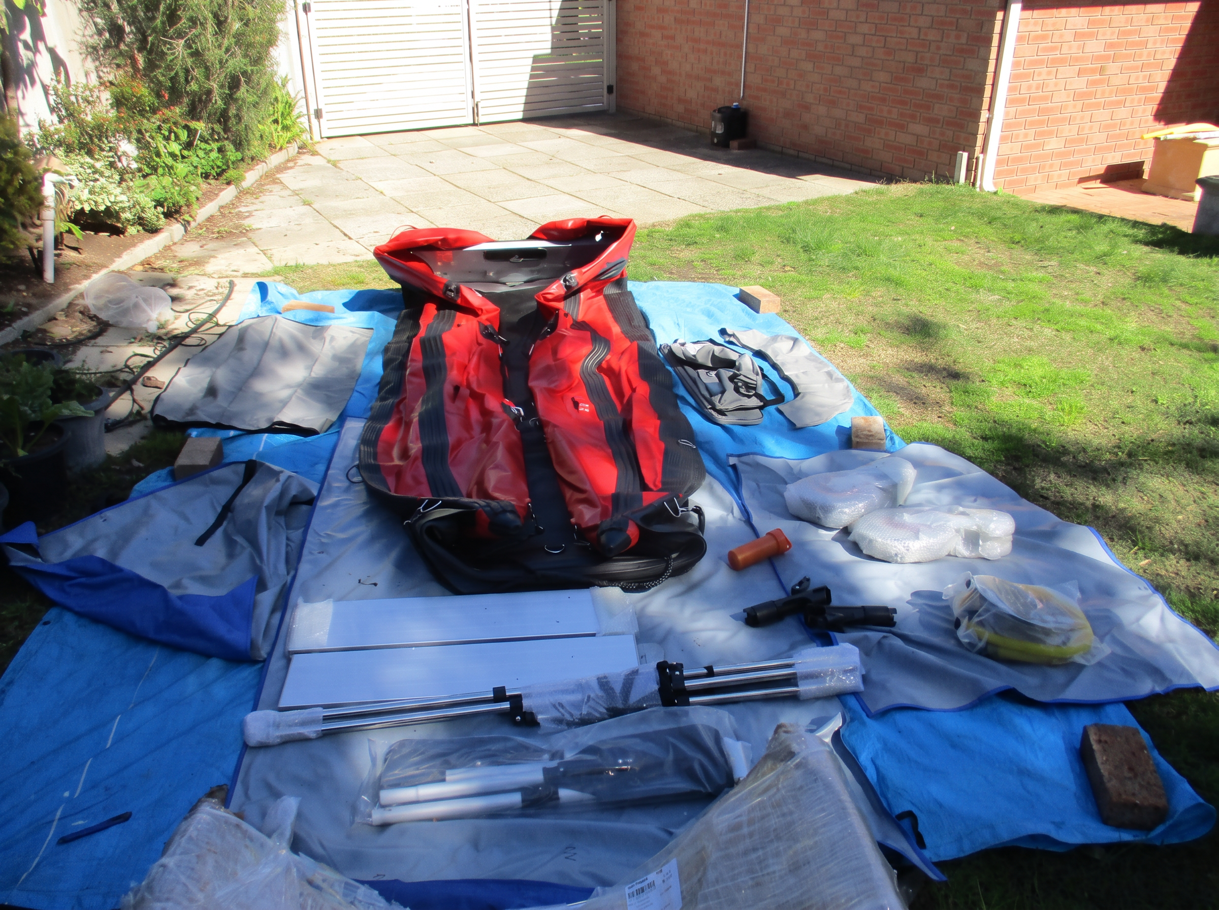 Aerowave Viper 330 and its full accessory pack laid out on tarps in a customer's driveway on delivery day