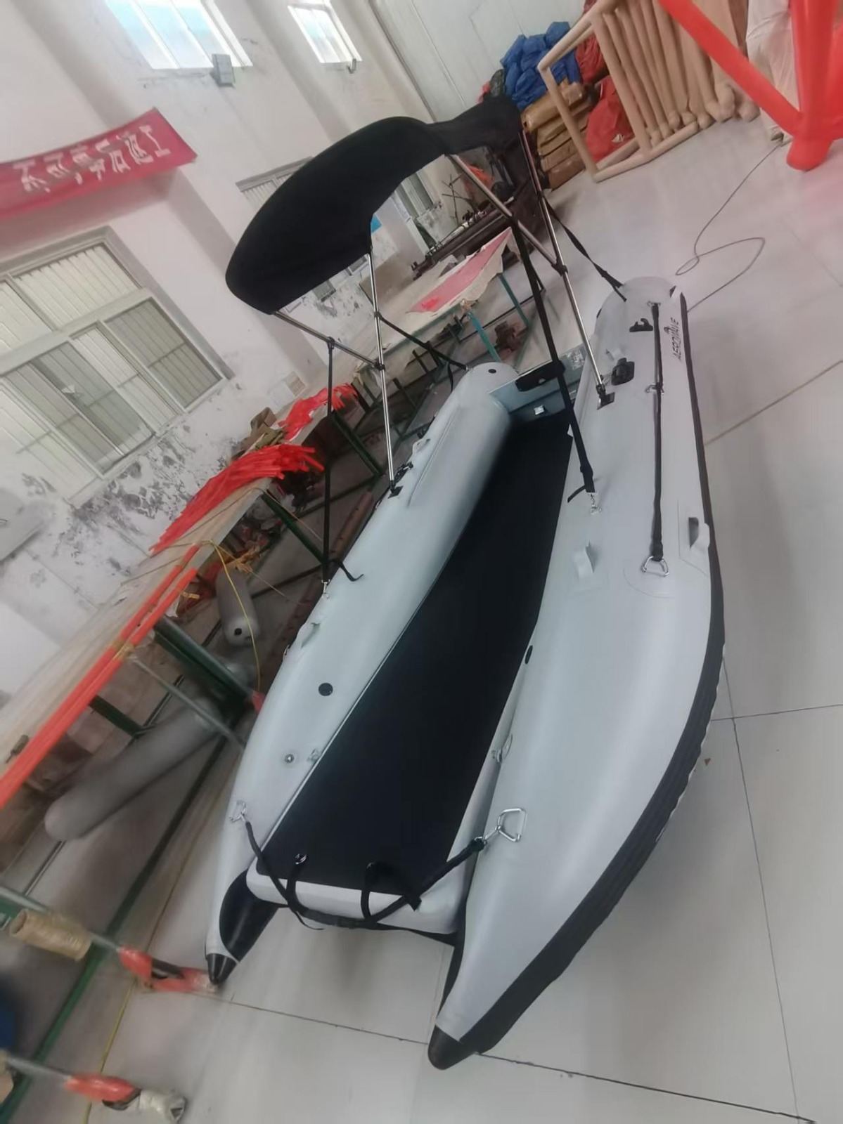Aerowave WaveRunner 380 inflatable catamaran from overhead, deck loaded with crew and gear