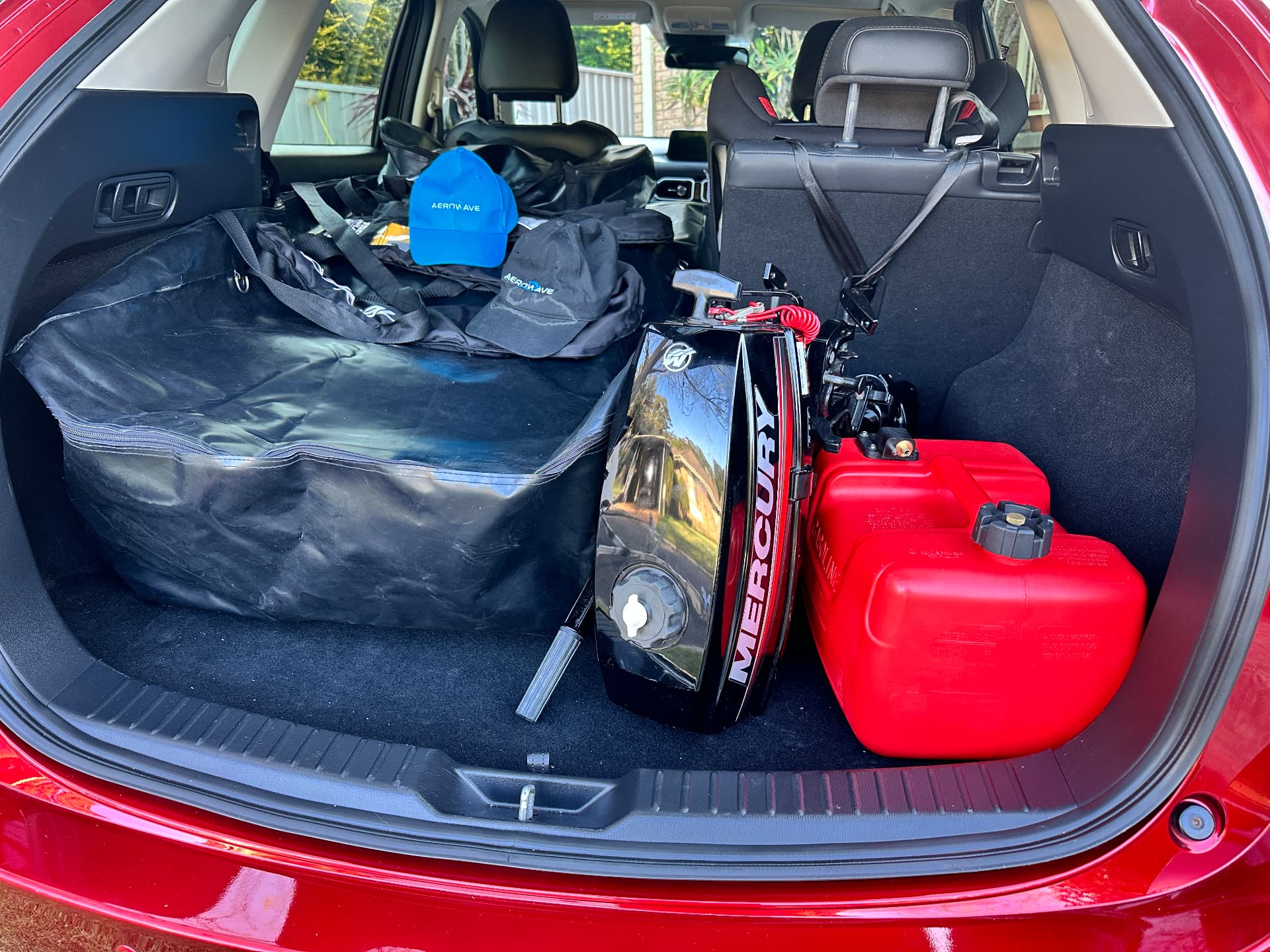 Packed Aerowave inflatable boat in a vehicle boot