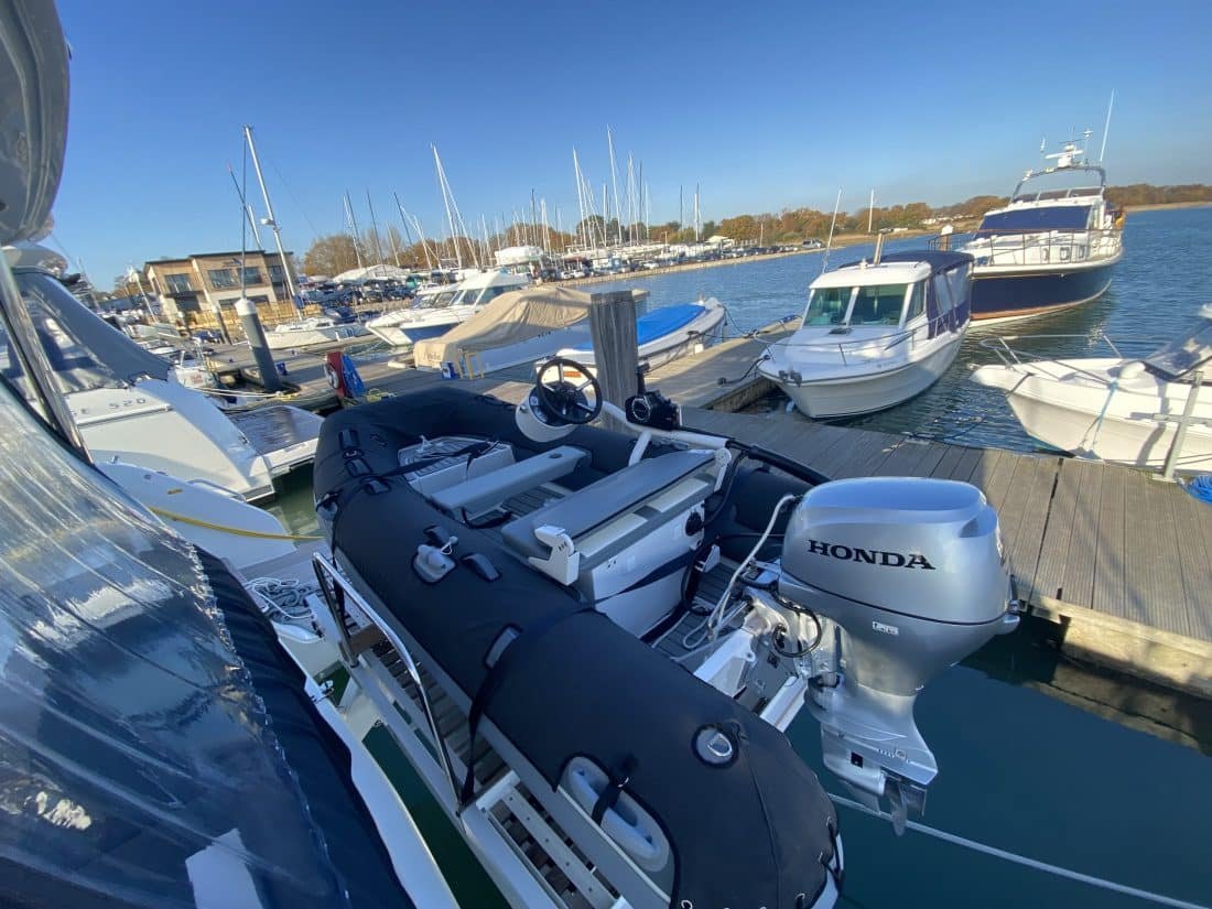 Dark tube chaps protecting a tender stored on davits