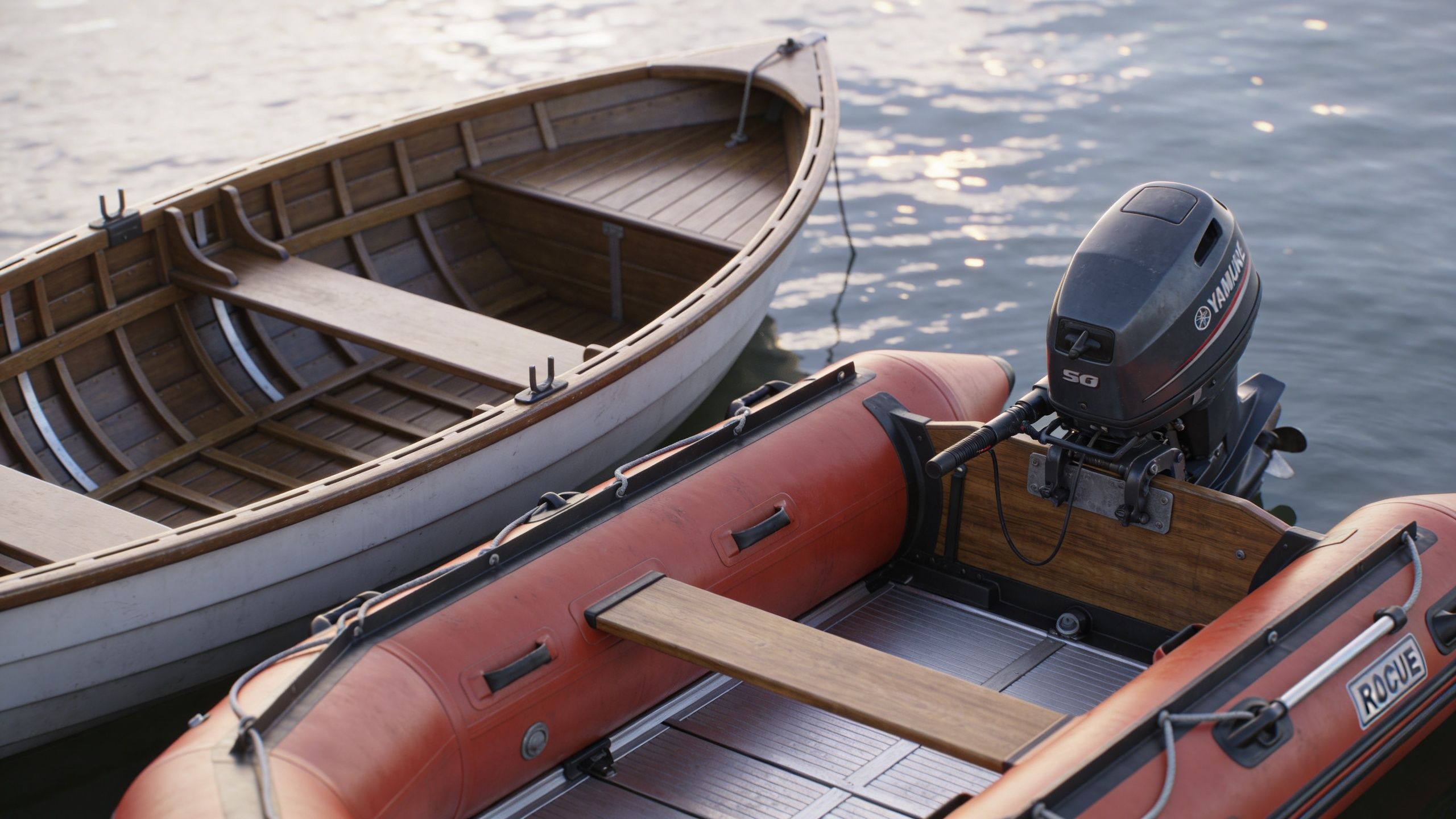 A wooden rowboat and an orange inflatable rescue boat with an outboard motor floating on calm water.